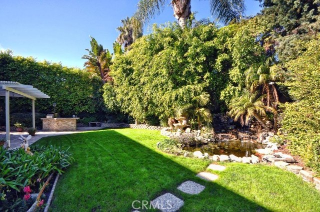 Lushly landscaped, waterfall and koi pond.