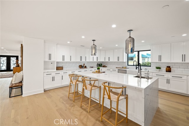 Impressive Center Island With Water Fall Quartz Conters, Prep Sink and Breakfast Seating