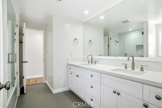 Shared full bath with double sinks.