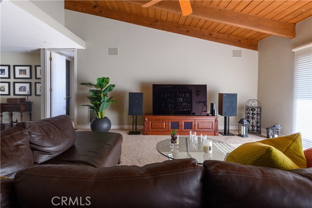 Living Room showing built-in stereo speakers in wall and view of Entry