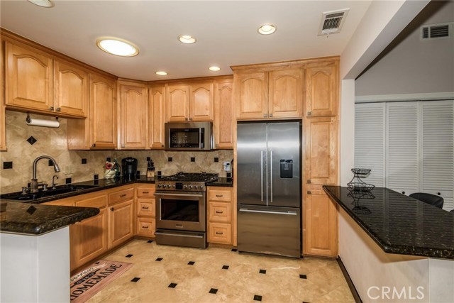 Remodeled kitchen with stainless steel appliances and granite counter tops