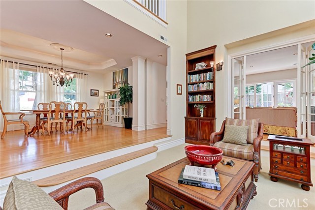 Sunken formal living room has custom built-in book cases.