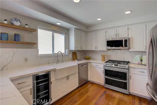 Lovely bright white kitchen with new wood floors, farm sink, Quartz counter tops and new wine fridge!