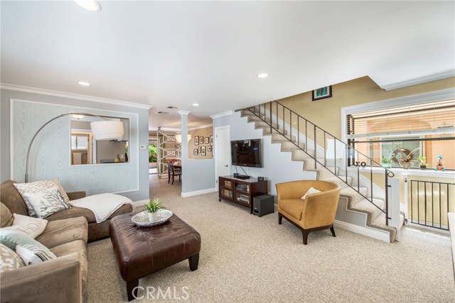 Living room with picture window on the right of the stairs