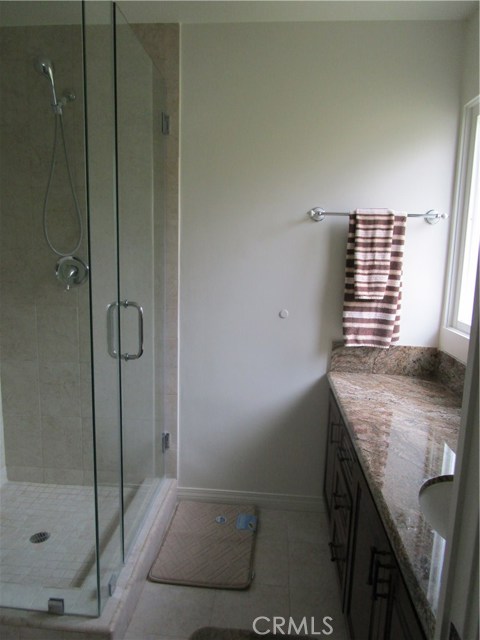 Master bath with shower and long vanity with lots of storage.