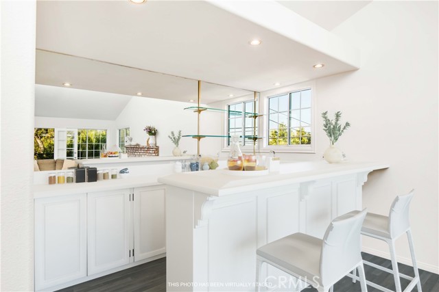 Photo has been altered to show the bar area painted white, floors hardwood and tile white.