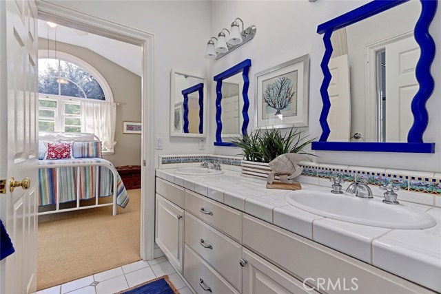 Upstairs guest bedrooms share a Jack-and-Jill bathroom with double sinks.