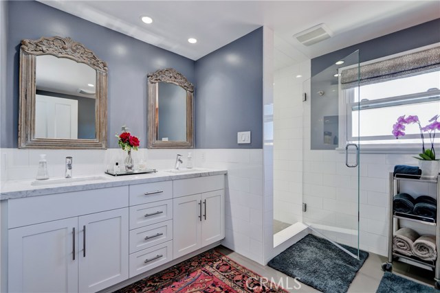 Such a calming way to start the day in this luxurious bathroom recently remodeled with double sinks and lovely shower.