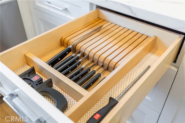 Built-in kitchen knife block in cabinetry, keeping the counter clean and clear for form and function.
