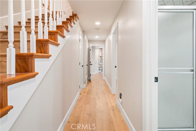Hallway to downstairs bedrooms and downstairs bathroom.
