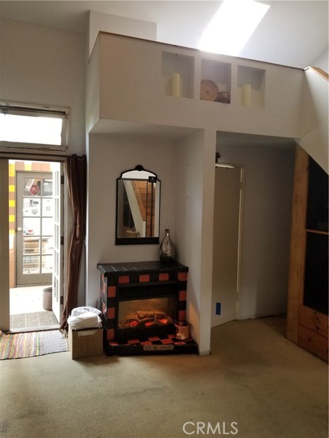 Guest quarters with loft, bathroom and electric fireplace.