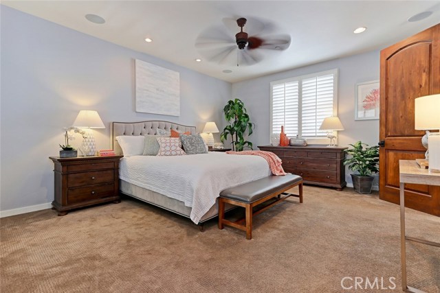 Spacious master bedroom with tall ceilings.