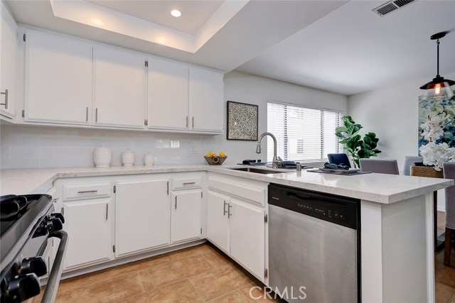 Love those gleaming white cabinets and stainless steel appliances!