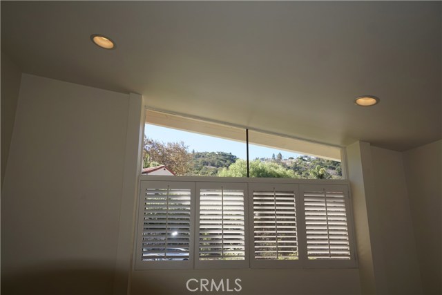 Master bedroom.  Look at the view. Clerestory windows provide light.  Angled high ceilings creates character. Recessed lights and smooth ceilings gives a modern feeling.