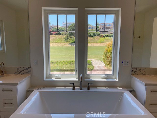 The Master Bathroom is highly upgraded with Quartz countertops, upgraded white cabinets,separate vanities, a separate commode, rain showerhead and custom closets!