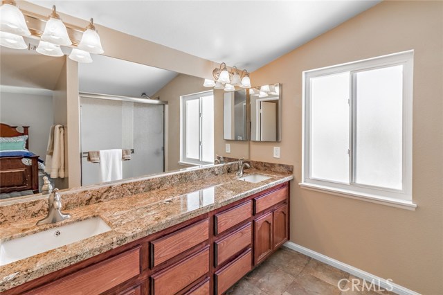 Master bathroom with dual sinks and granite counter tops