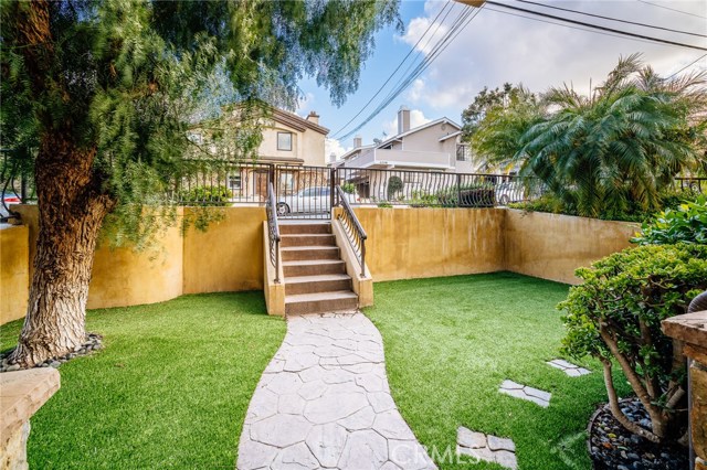 The front yard is enclosed and features artificial grass. Great for play, relaxing...