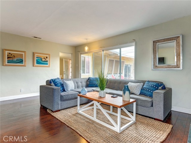 The natural light and stone fireplace provides the perfect setting to relax in the spacious living room.