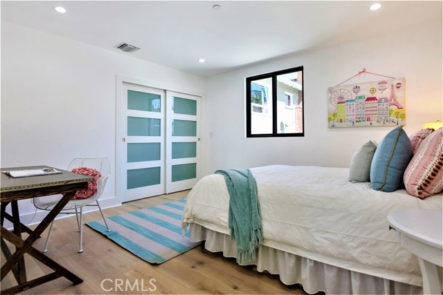 The 5th Bedroom has Can Lighting, a Large Closet with Built-ins, a Glass Panel Closet Door, Large Windows and Large Casing and Molding
