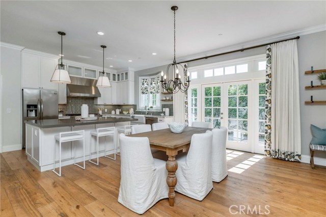 Warm and delightful is the feeling you get standing around the massive island, enjoying the peeks of greenery and light from the bay windows and french doors flanked with side and transom windows.