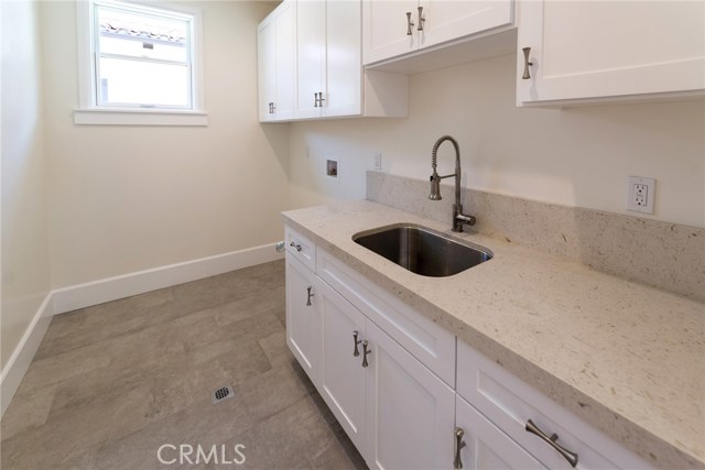 Laundry room is upstairs and has lots of storage and quartz counter.
