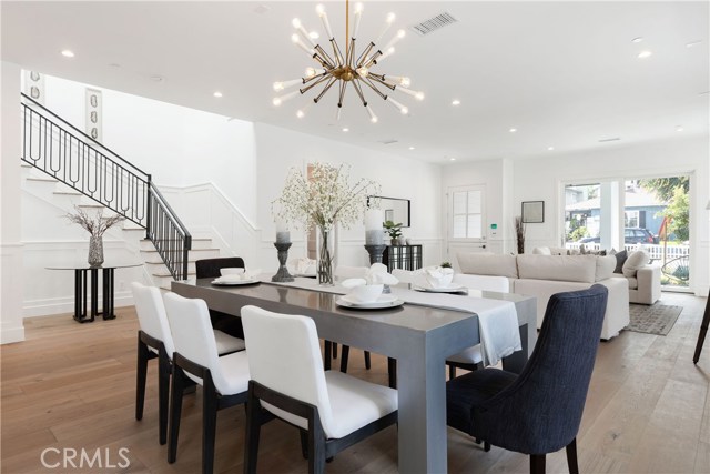 Dining area and adjoining living room with French doors that open to the charming front patio