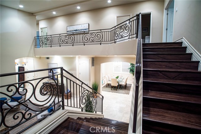 Showing off the distressed wood flooring and the upgraded wrought iron railing