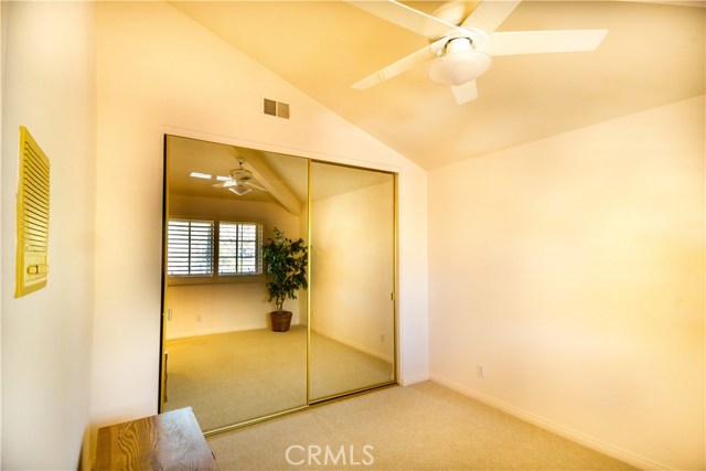 Upstairs bedroom with new carpet and new paint. Sliding mirror closet, ceiling fan, plantation blinds on window.