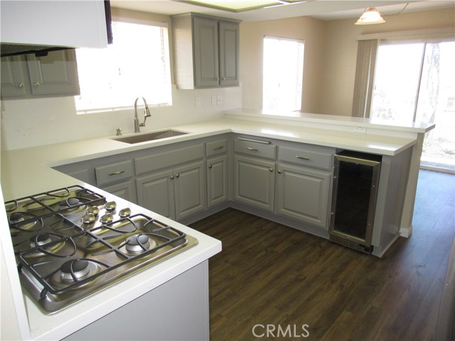 Kitchen Pic #1 New 5 burner stove top, New Stainless Steel Sink, Refrigerated Wine Rack, New Quartz Counter Tops, Refurbished and Newly painted cabinets. Breakfast Eating Area with ocean view and Counter Top Dining