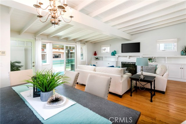 Spacious living area with sliders opening to balcony.  Slightly vaulted beamed ceiling throughout home