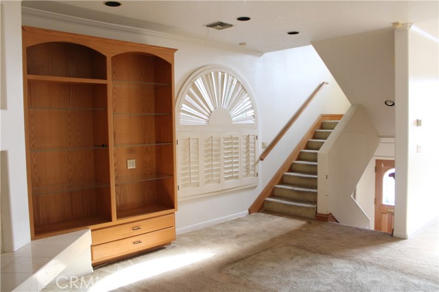 Built-ins surrounding fireplace/stairs to the bedroom area