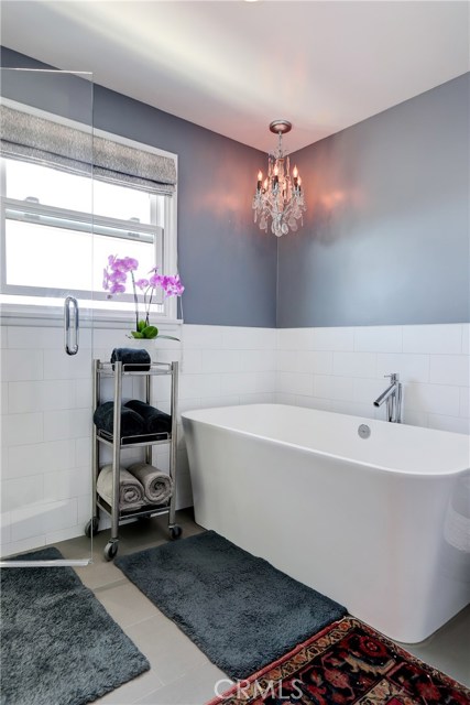 Breathtaking upstairs bathroom, recently remodeled with a freestanding tub and chandelier.