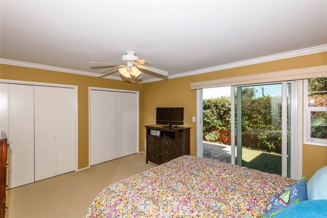 Master bedroom with sliding doors leading out to backyard.