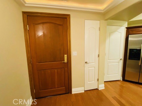 Solid Wood Front Door. Thin Door to Tankless Water Heater. Pantry Door is next to Refrigerator.