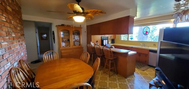 Dining and breakfast bar with Kitchen view of parklike back yard.