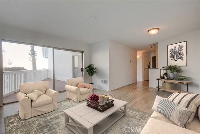 Another angel of virtually staged living space showing area big enough for dining room and open to the kitchen.