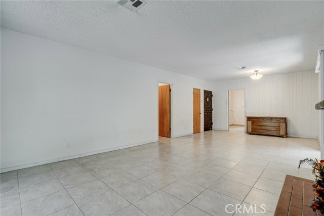 This view from the living room side shows the view of the front door, hall door and door to the kitchen and laundry room.