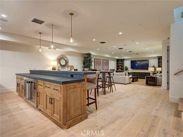 HUGE 1,557 sq. ft. entertainer's dream basement with full bar, dishwasher, ice maker, fridge, 86" TV already installed, surround sound, wired for Dolby Atmos 9.4.2 channel cinema, lounge area, half bath, downstairs bedroom suite.