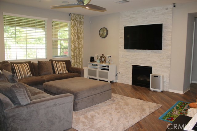 Gas fireplace with stone backsplash for a large mounted TV.