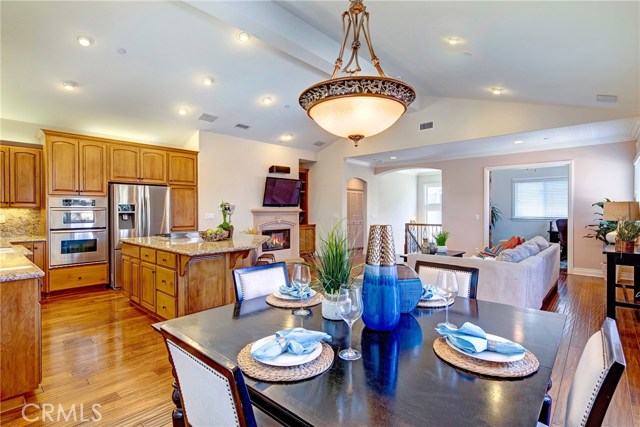 Huge open floor plan, tons of natural light, beautiful engineered hardwood floors, fireplace, and adjacent den/office with French doors that could be converted to a 4th bedroom.