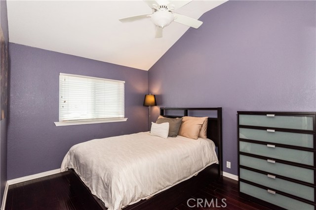 Another bedroom filled with natural light, soaring ceilings and abundant storage