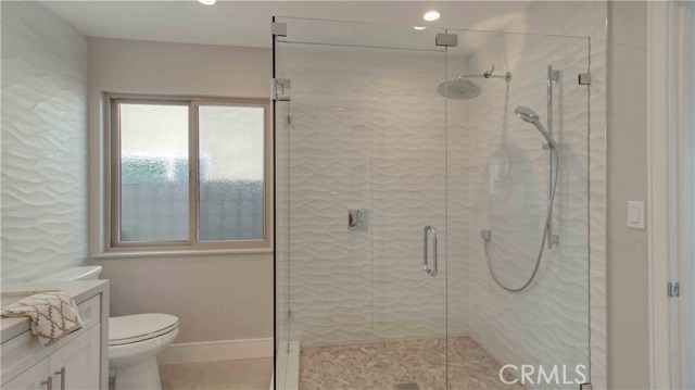 Extra large shower stall, custom tile, chrome faucets, frameless glass enclosure