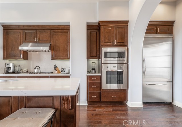 An airy gourmet kitchen fully appointed with Quartz countertops, Viking appliances and French doors to the courtyard patio.