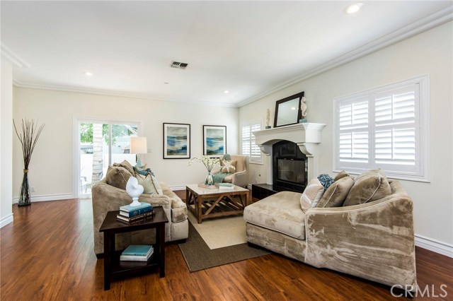 Enormous family room opens to the patio, with a statement mantle framing the elevated fireplace.