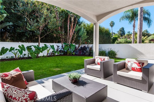 Covered patio off family room. An open patio extends beyond the two chairs.  Access from breakfast area, as well