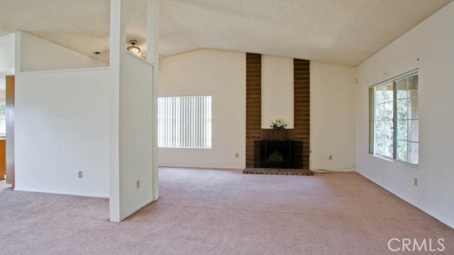 Living Room with Fireplace. Notice the High Celings.