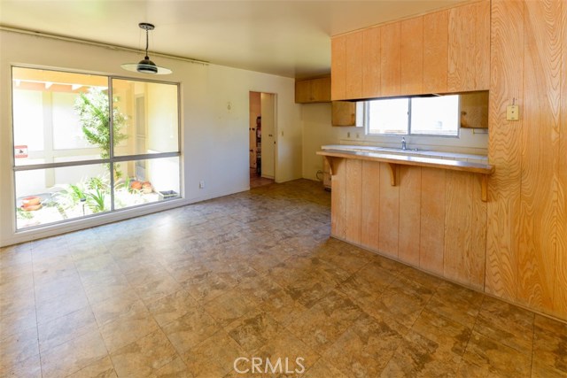 Large kitchen with spacious dining area, adjacent to laundry room.