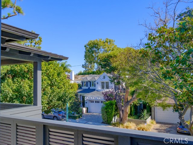 Bedroom #3, East Facing Private Outdoor Patio with Two French Doors and Porcelain Tile Floor and a Custom Louvered Solid Wood Treatment for the wall. Convenient Water Spigot is located on all the Patios. Note the view of mature trees along Pine Avenue. Kids have called this the "Tree House" room!