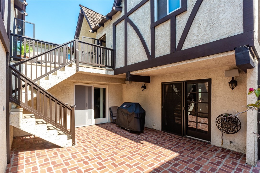 Downstairs patio.  Stairway leads to upstairs deck and provides a private entrance to the guest suite.  Gas hook-up for barbeque