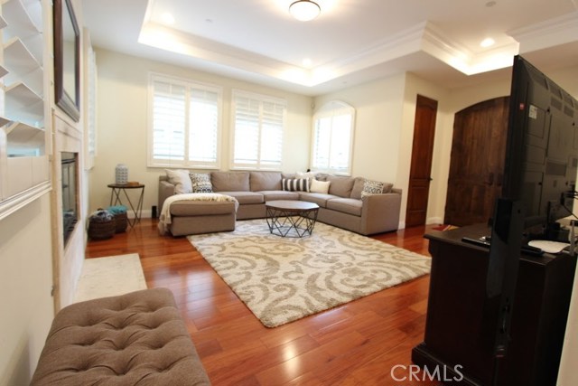 Living room with forward facing windows, different angle. Solid eight-foot wooden panel doors.
